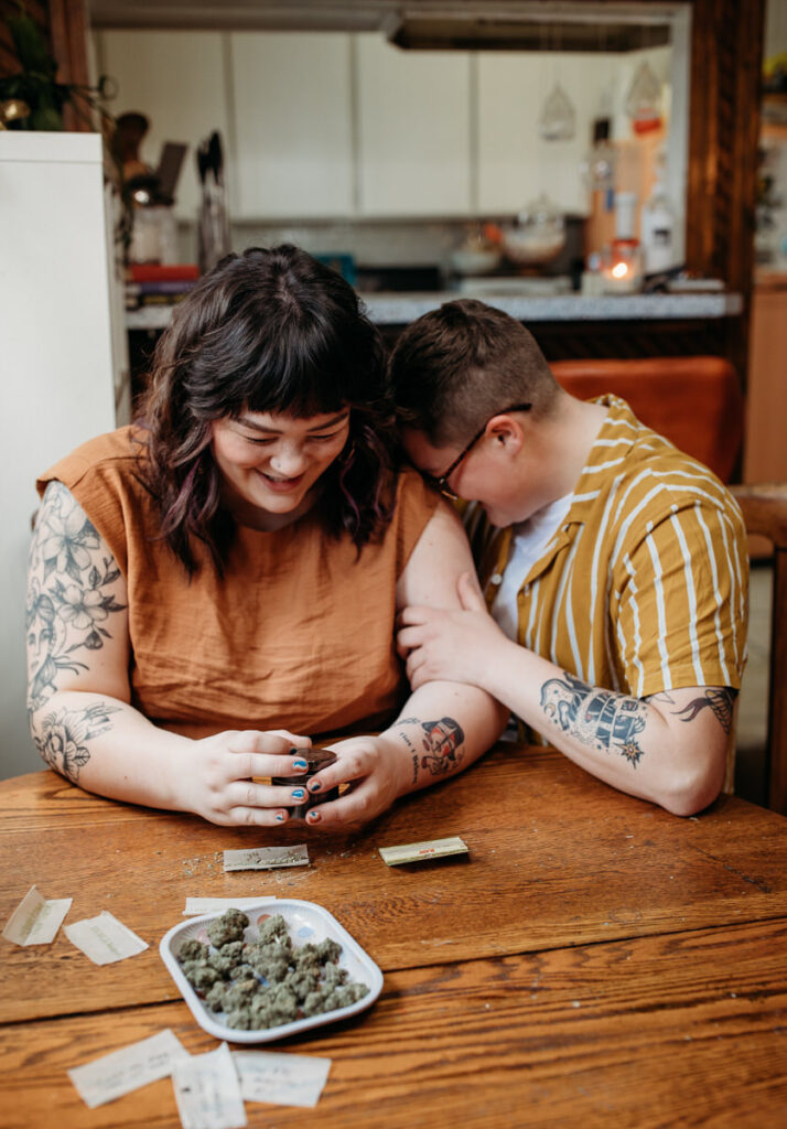 An intimate moment captured at a home kitchen table, where a couple shares a smile